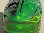 Green dirtbike helmet with stars and old school flames