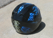 True fire blue skull full face motorcycle helmet with spine and brain exposed as well as airbushed visor.